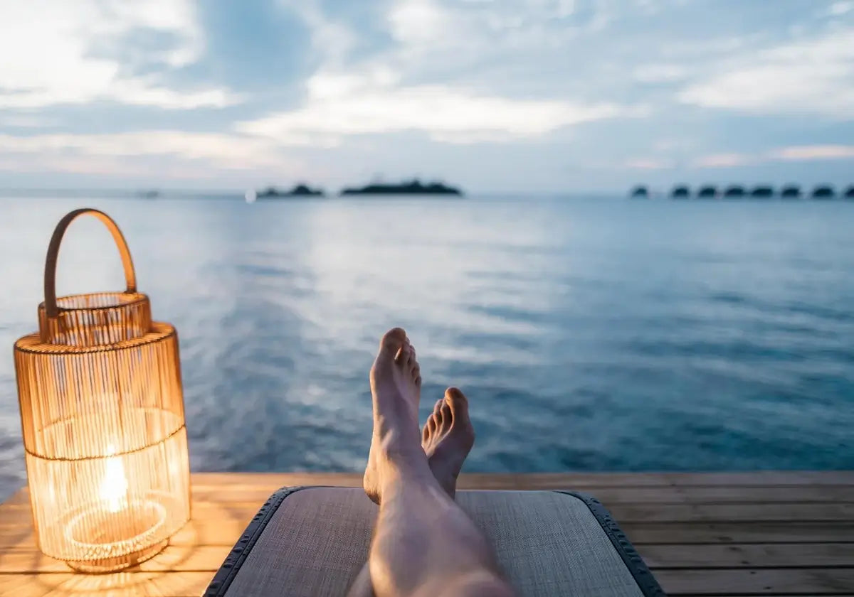 Image of person's legs in front of a body of water