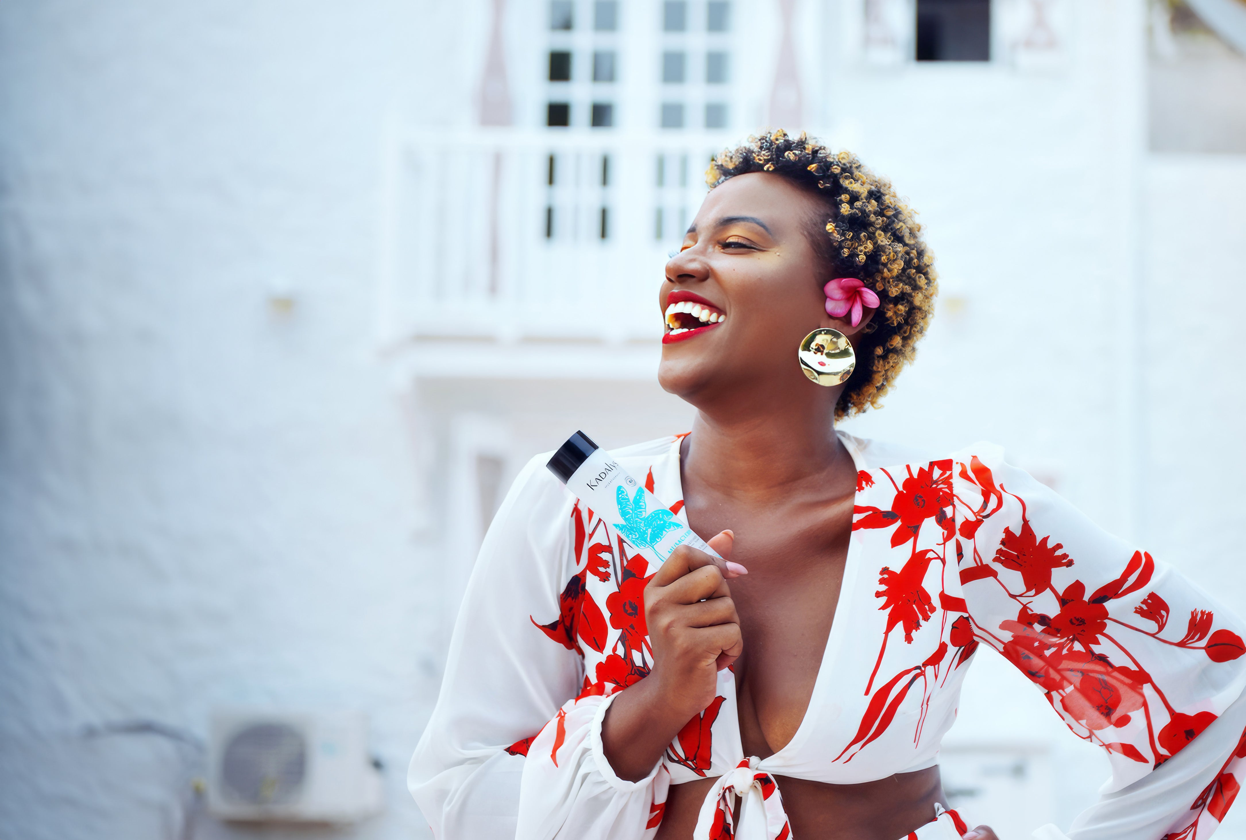 Image of woman holding the Kadalys Toner in front of a white building