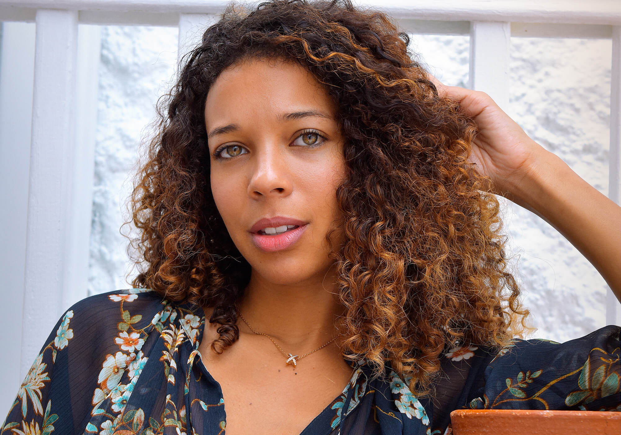 Image of woman with brown skin in front of a white background