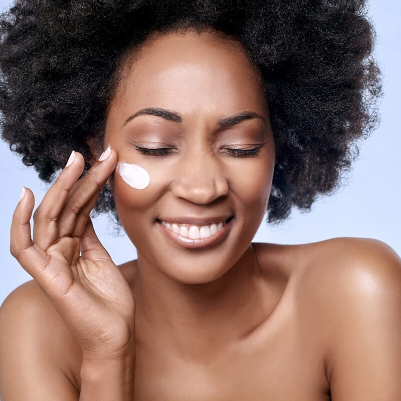 Woman applying face cream