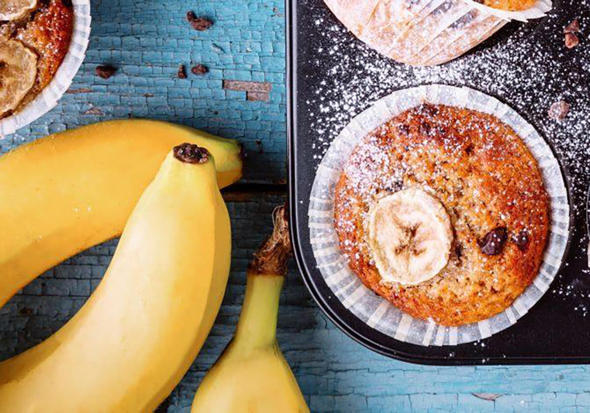 Banana Chocolate muffin next to bananas on a table