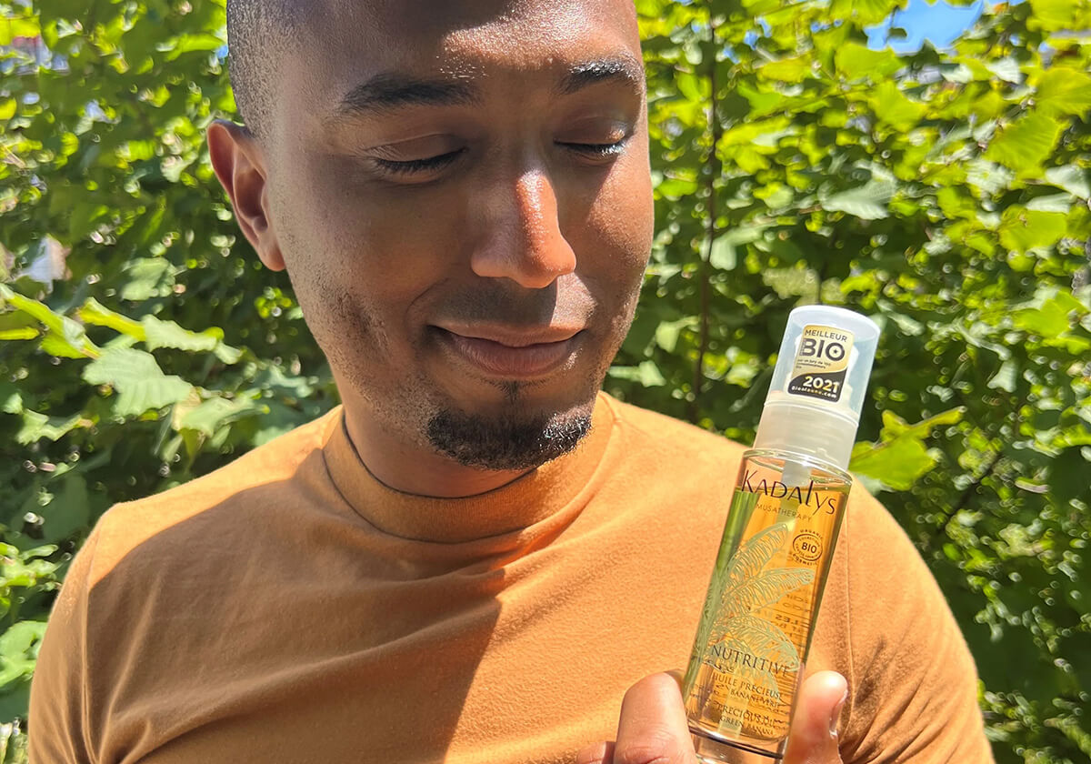 Man holding Nutritive Precious Oil made with Banana Bio-actives