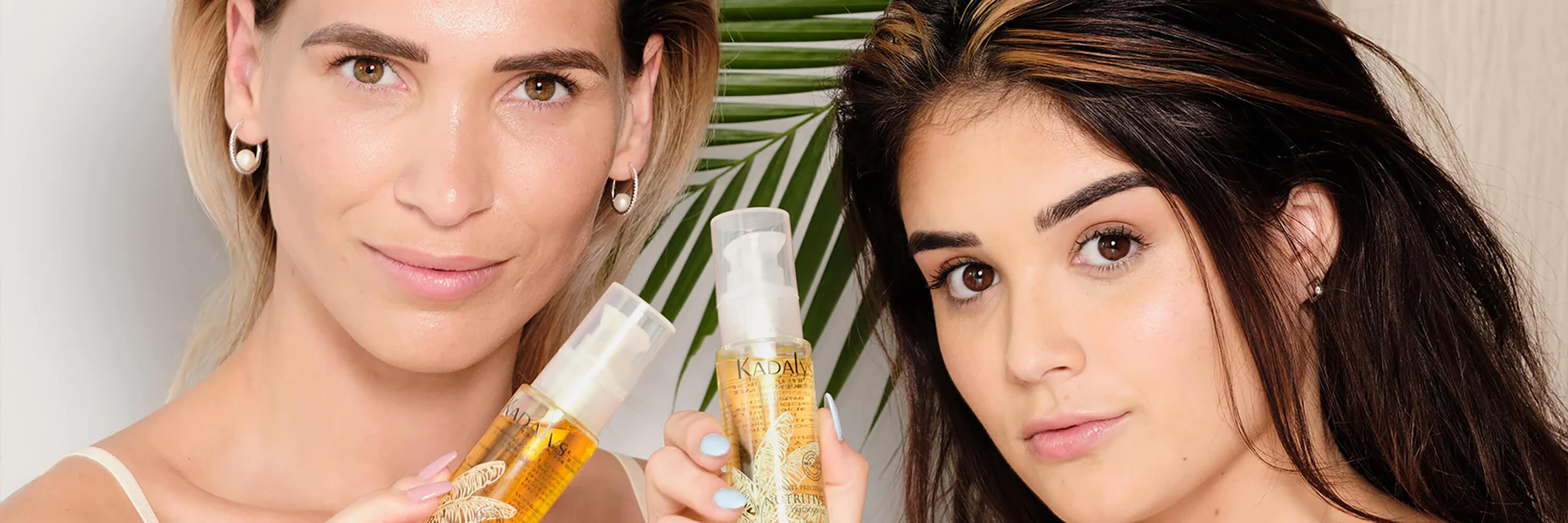 Image of two women holding Kadalys face oils | face and hair oil products
