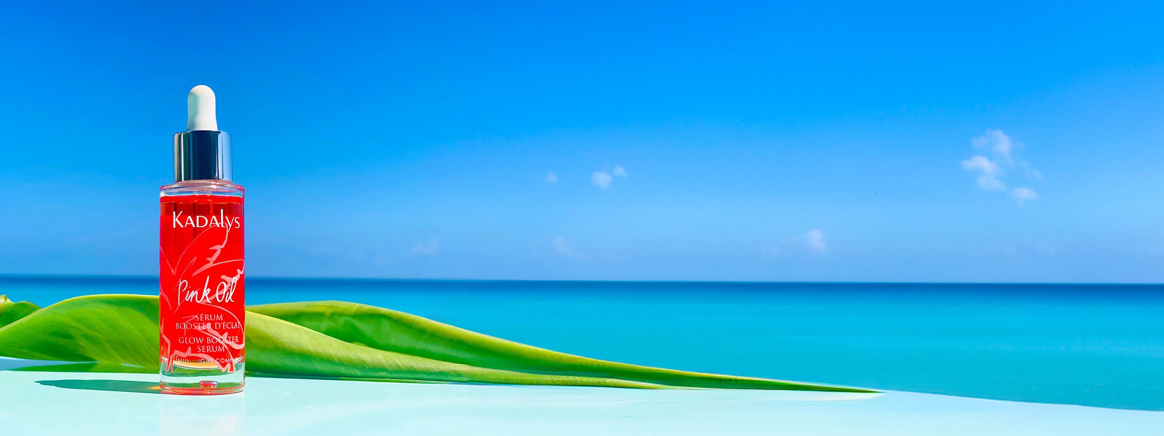 Image of pink banana oil in front of blue sky | Sustainable skincare made from upcycled banana bio-actives