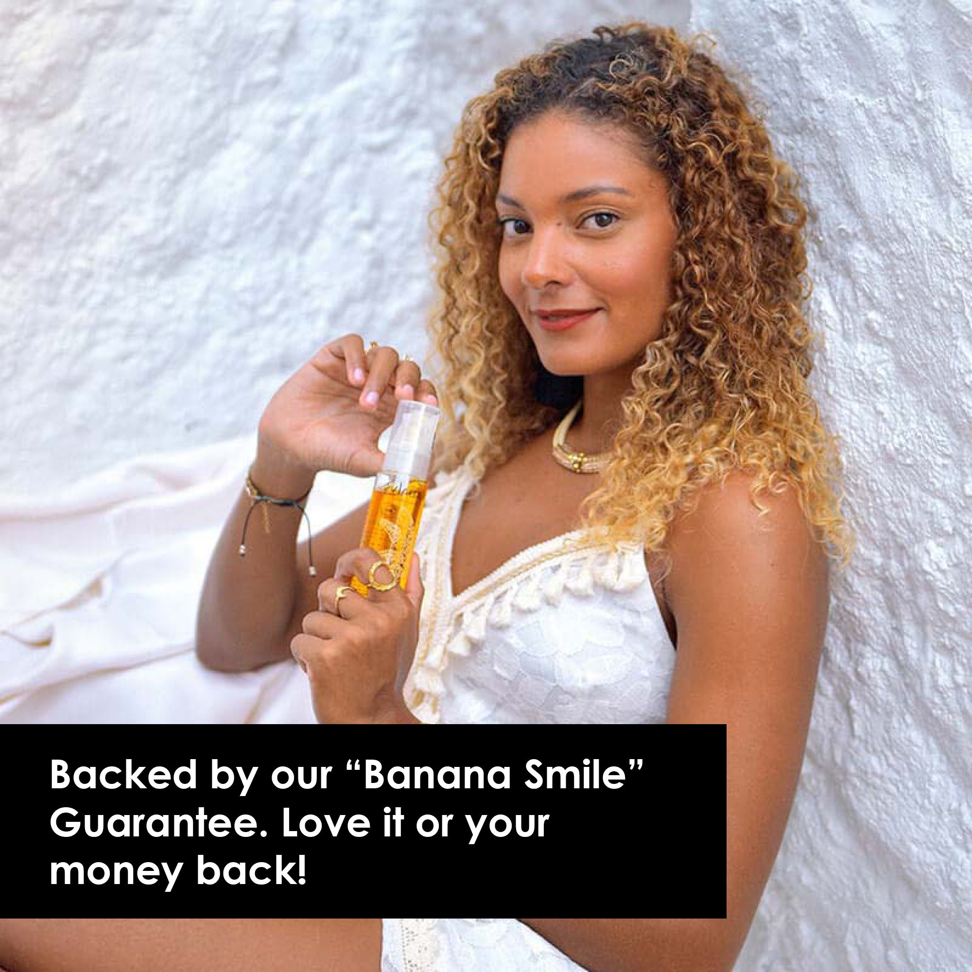 Image of woman holding radiance face oil in her hands against a white stucco background. Caption reads: Love it or you money back.